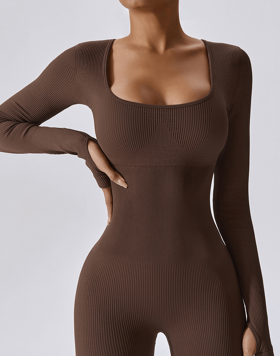 Woman wearing seamless yoga suit with thumb holes, designed for unrestricted movement and a sleek look in fitness routines.